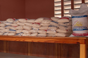 Bags of rice on a shelf in a market stall
